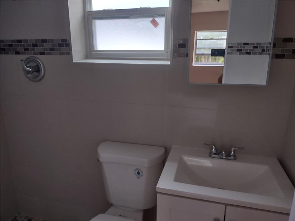 128 Miami Gardens Road West Park, FL 33023 - Photo 28 of 38 a bathroom with a sink and toilet