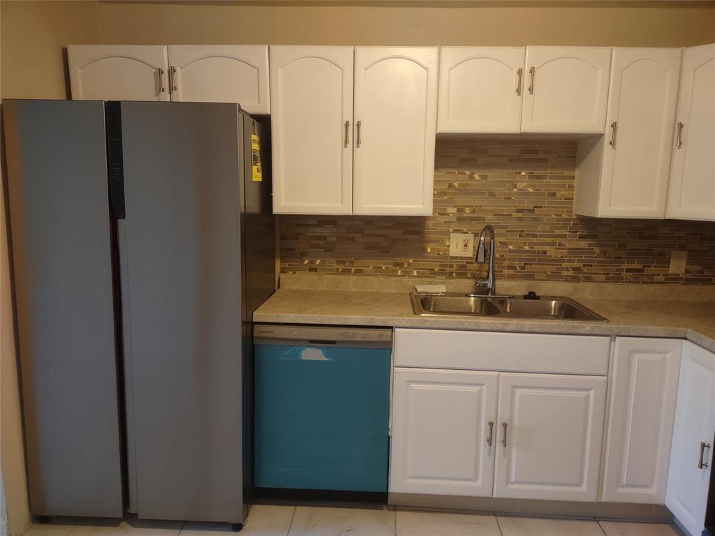 128 Miami Gardens Road West Park, FL 33023 - Photo 8 of 38 a kitchen with stainless steel appliances white cabinets and a refrigerator with a sink