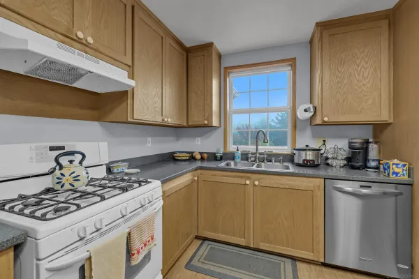 a kitchen with stainless steel appliances granite countertop a refrigerator and a stove top oven