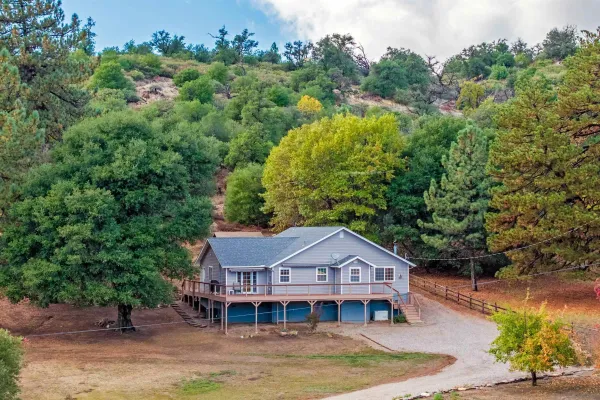 an aerial view of a house with a big yard