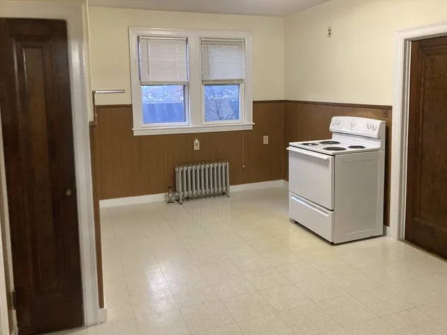 a kitchen with windows and cabinet