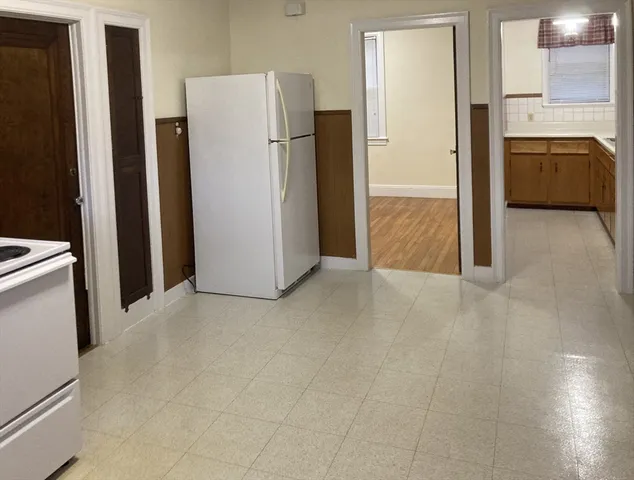 a view of a kitchen with a refrigerator a stove top oven a refrigerator and a stove