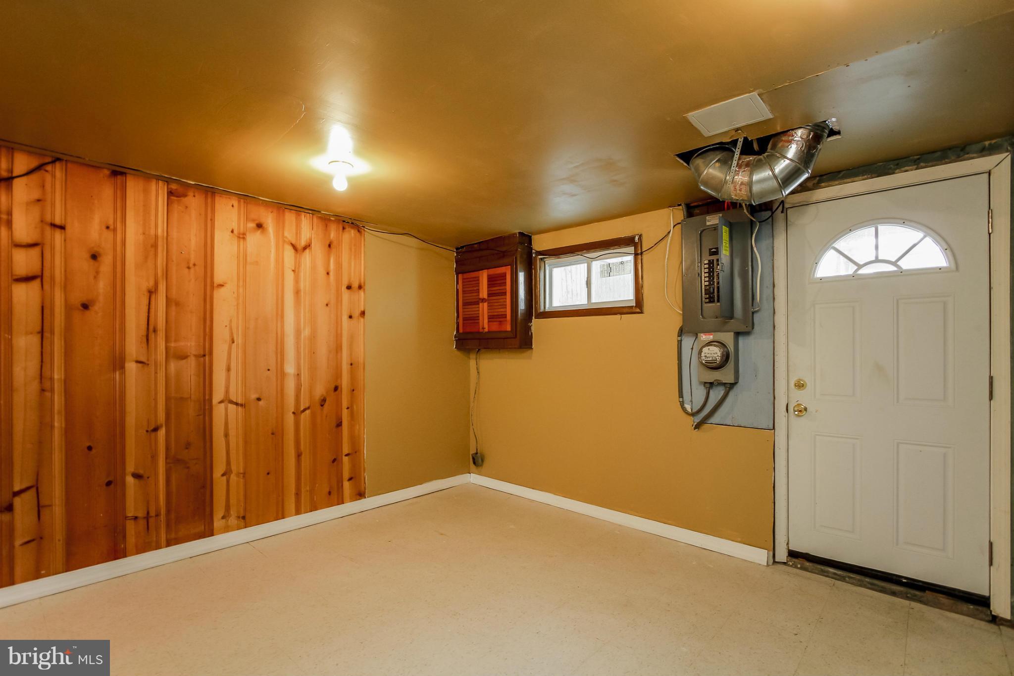 4820 Greencrest Road Baltimore, MD 21206 - Photo 22 of 30 a view of a hallway with a wooden door