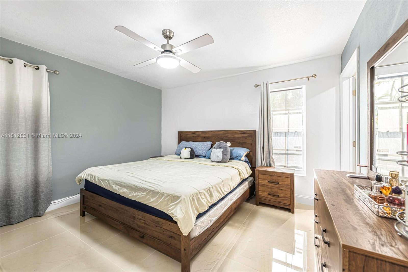 Palmetto Estates Miami, FL 33157 - Photo 19 of 29 a bed sitting in a bedroom next to a window