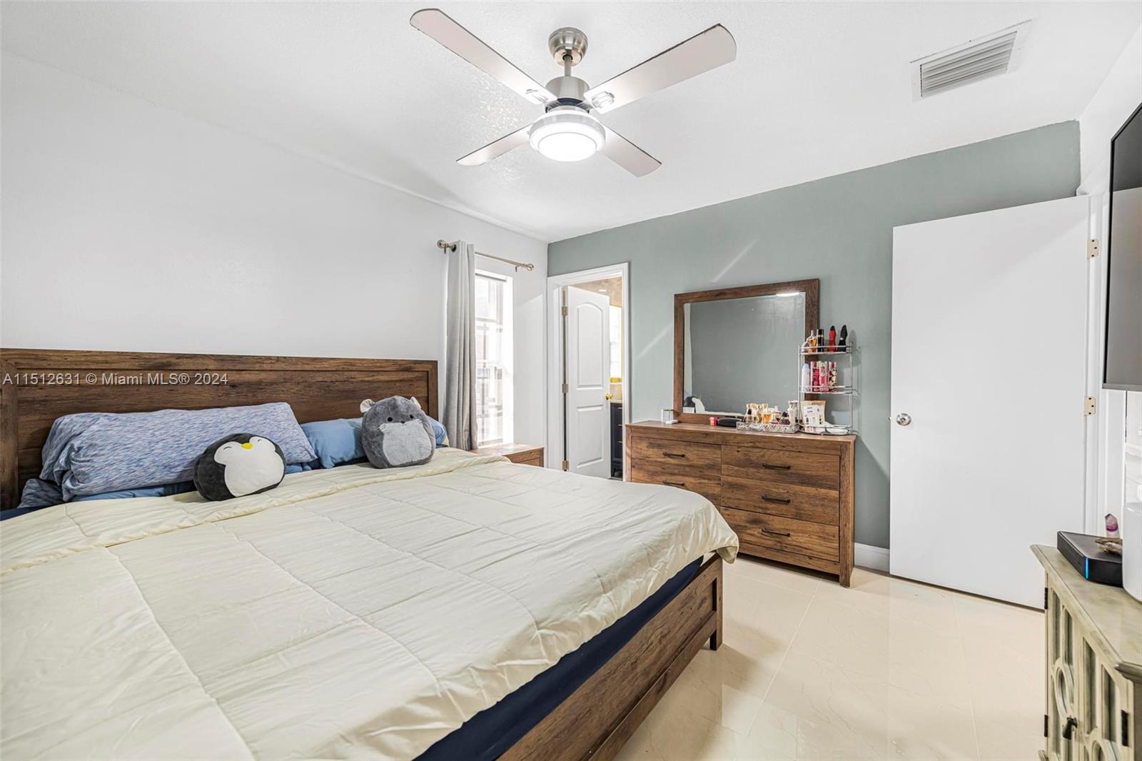 Palmetto Estates Miami, FL 33157 - Photo 20 of 29 a bedroom with a bed and a chandelier