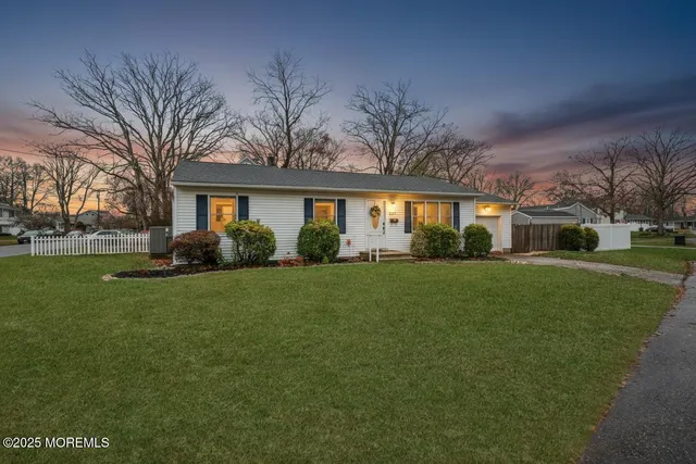 a front view of house with yard and green space