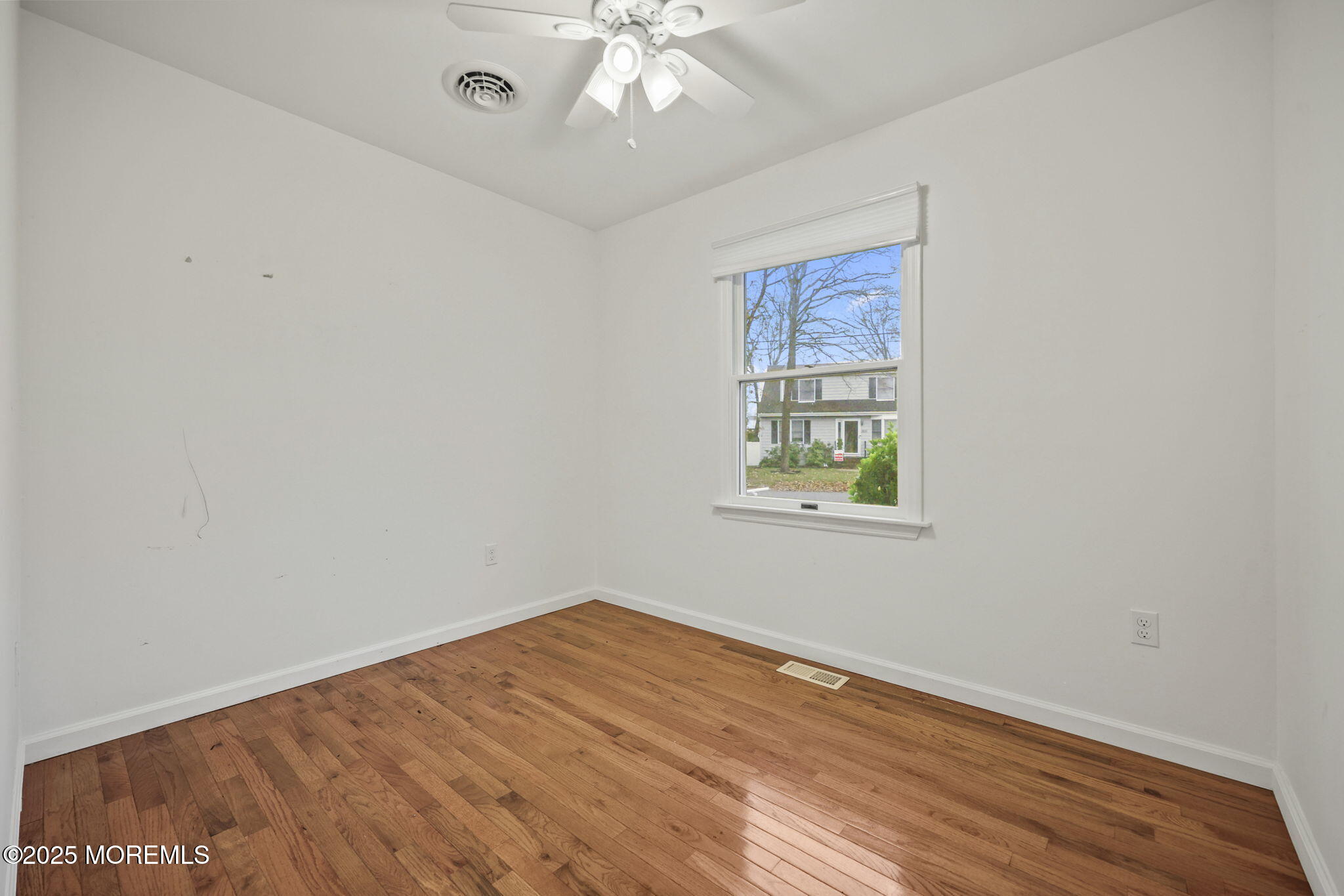 601 Marshall Drive Point Pleasant, NJ 08742 - Photo 12 of 21 wooden floor in an empty room with a window