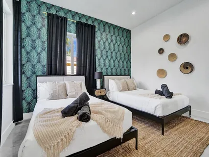 a bedroom with two beds and painted walls