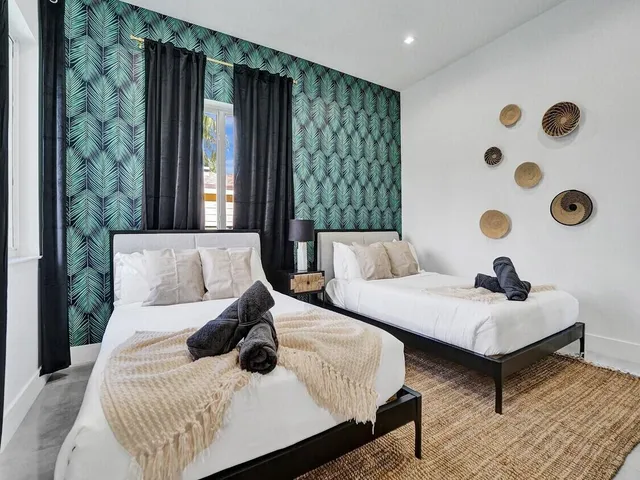 a bedroom with two beds and painted walls