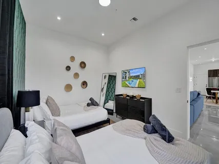 a living room with furniture and a hallway