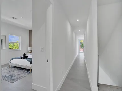 a living room with a bed a couch and potted plant with potted plants