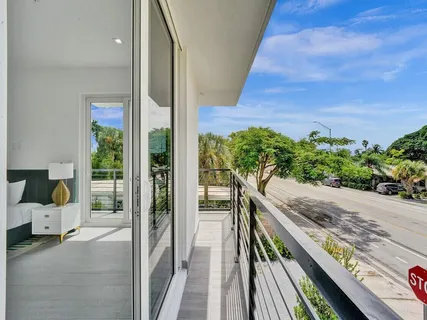 a view of a hallway with furniture and floor to ceiling window