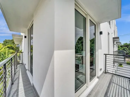 a living room with a bed furniture and a large window