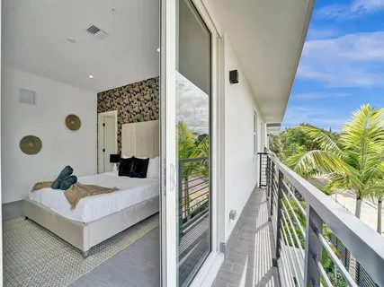 a large white kitchen with kitchen island a sink stainless steel appliances and cabinets