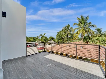 a outdoor sitting area with furniture and city view
