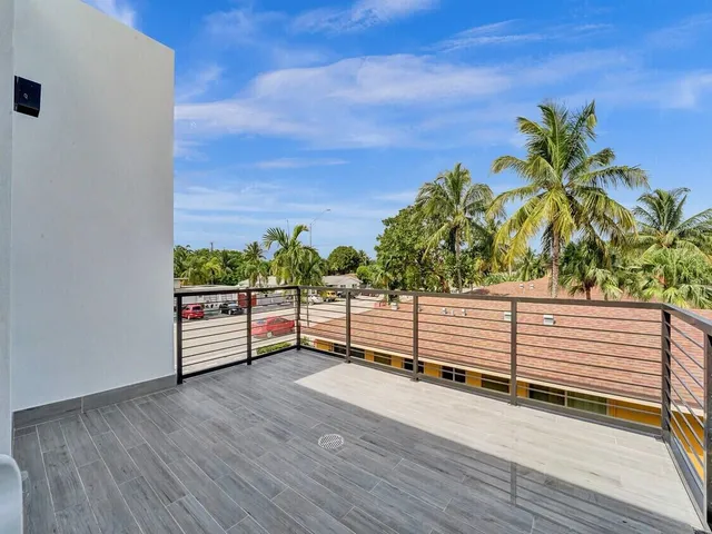 a outdoor sitting area with furniture and city view