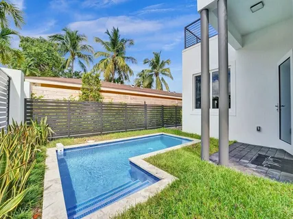 an aerial view of a house with balcony and outdoor seating