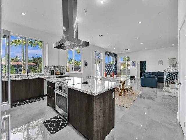 a kitchen with a sink a counter space appliances and cabinets