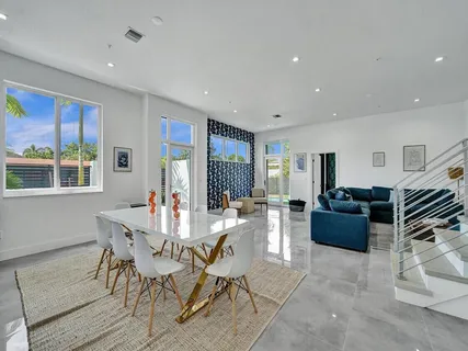 a living room with furniture and kitchen view