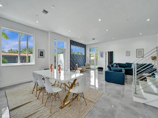 a living room with furniture and kitchen view