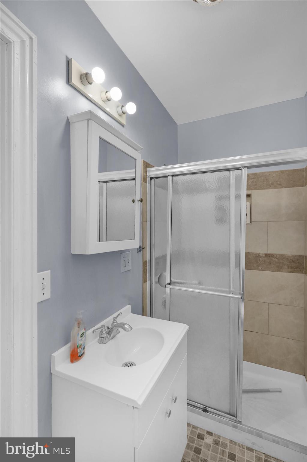 324 North 12th Street Reading, PA 19604 - Photo 18 of 27 a white kitchen with a sink a refrigerator and cabinets