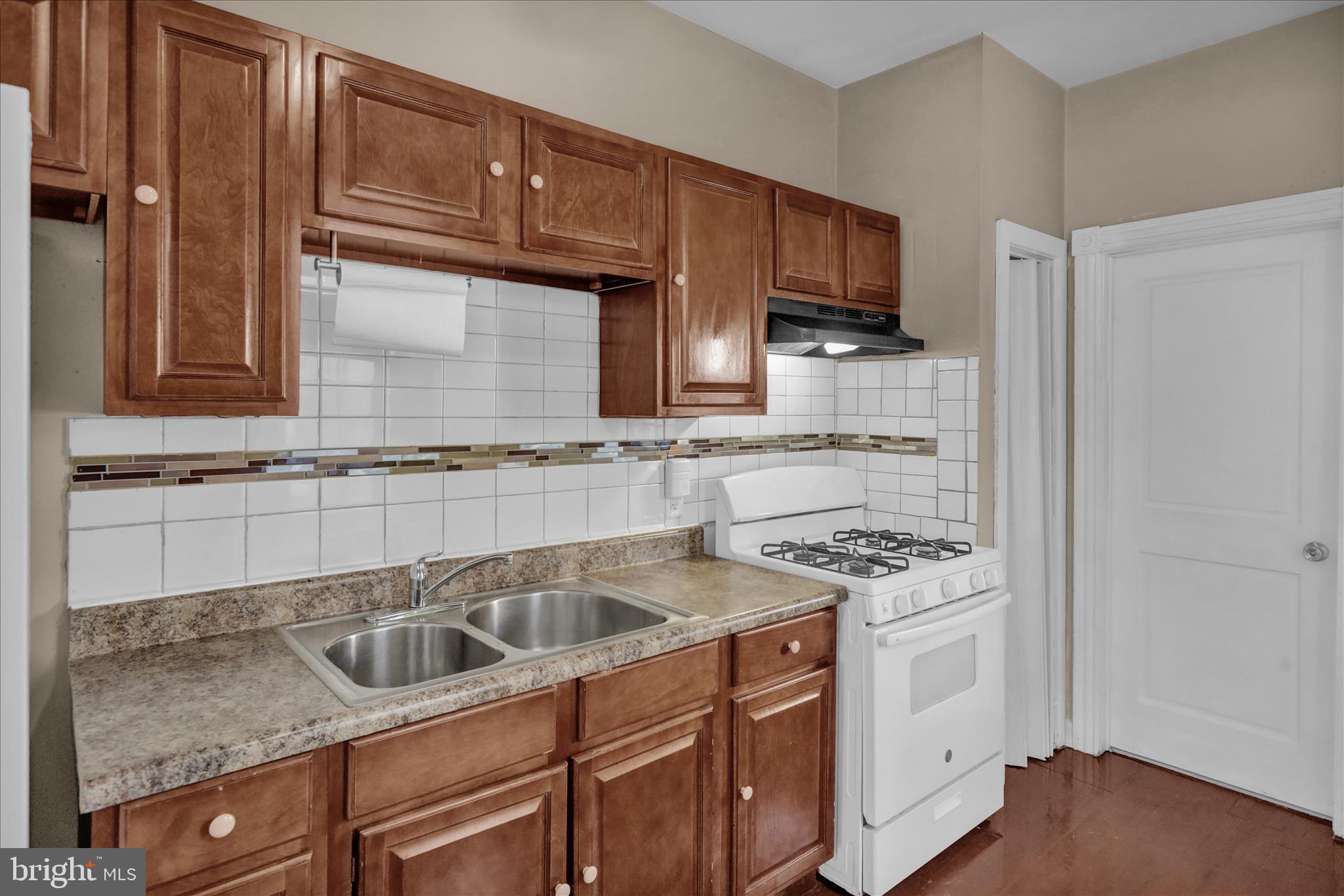 324 North 12th Street Reading, PA 19604 - Photo 8 of 27 a kitchen with stainless steel appliances granite countertop a sink stove and cabinets