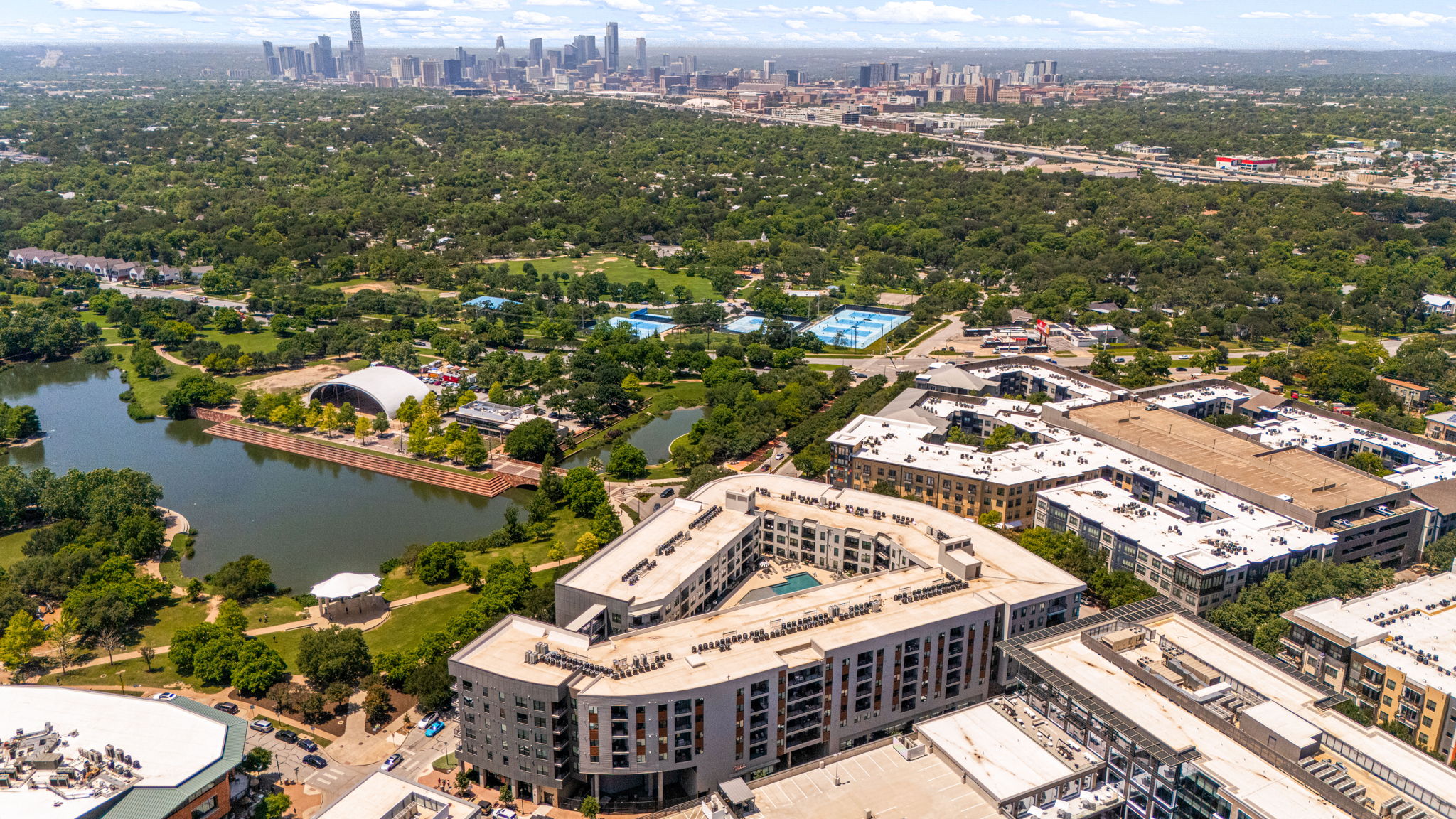 1701 Simond Avenue, Unit 612 Austin, TX 78723 - Photo 39 of 40 Aerial perspective featuring a modern multi-story building with a rooftop pool and surrounding green spaces