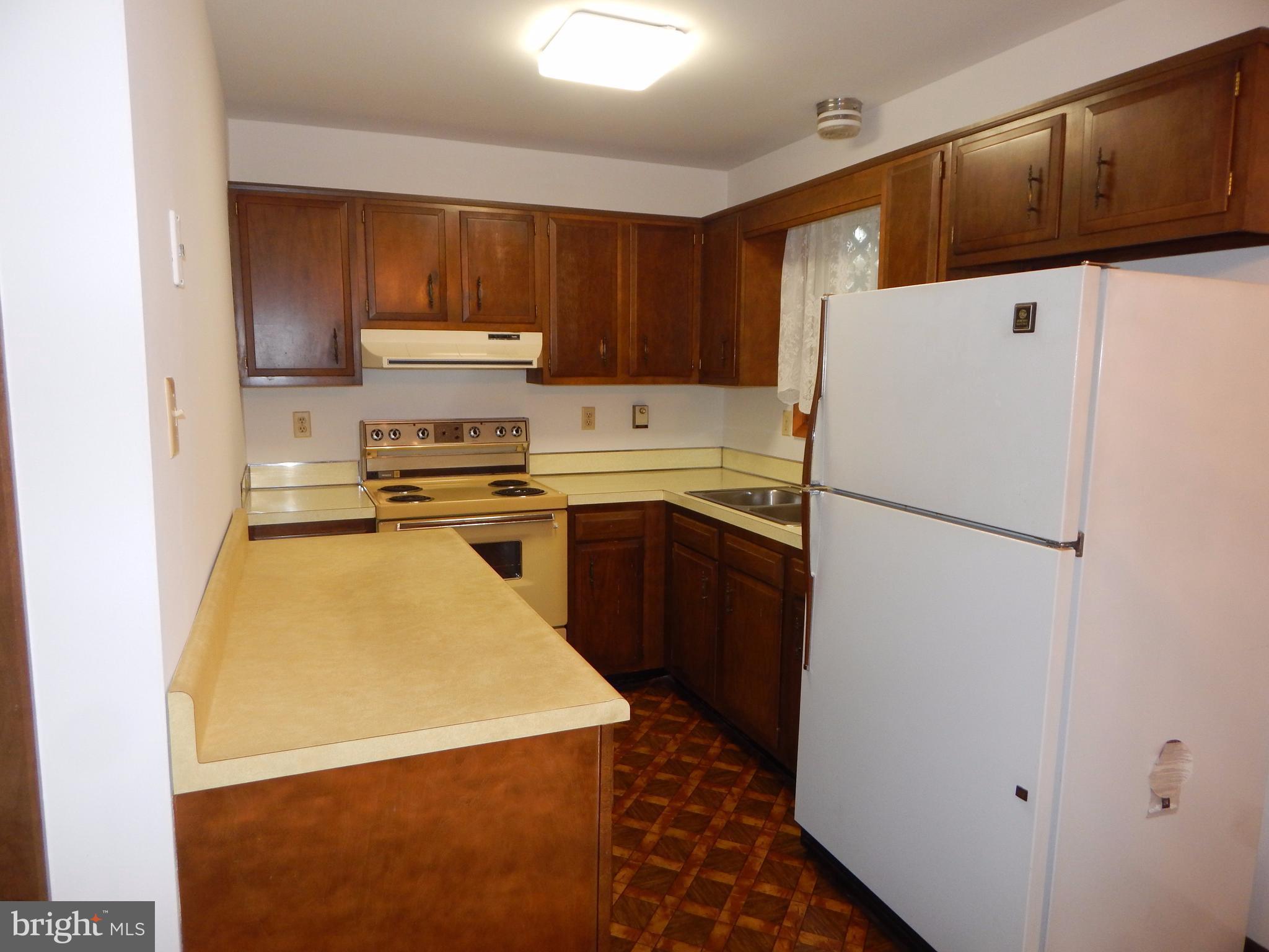 83 Wakefield Road Hagerstown, MD 21740 - Photo 4 of 22 a kitchen with stainless steel appliances granite countertop a refrigerator a stove a sink dishwasher and a refrigerator with wooden cabinets