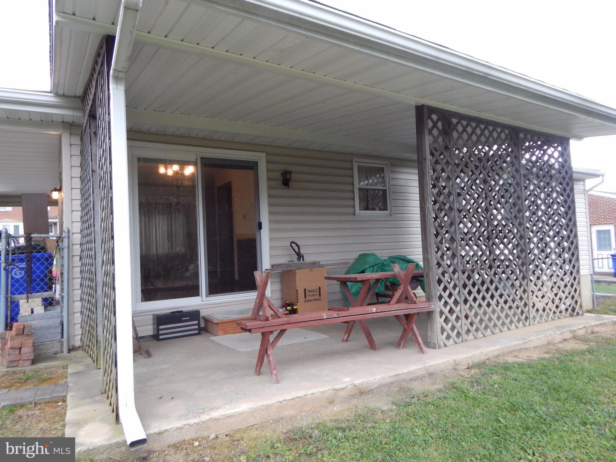 83 Wakefield Road Hagerstown, MD 21740 - Photo 6 of 22 a wooden bench sitting in front of a building