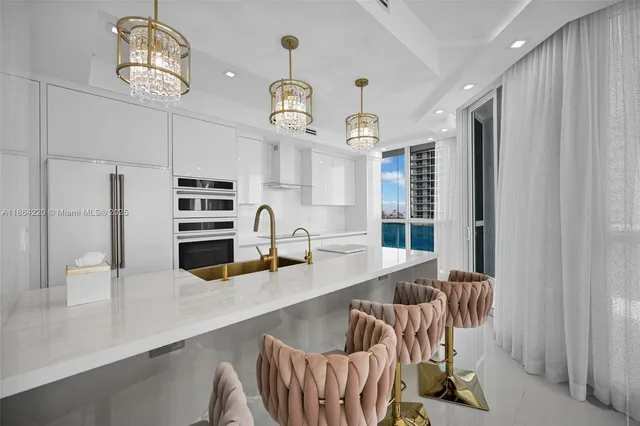 a kitchen with stainless steel appliances granite countertop a sink a stove and a wooden floors