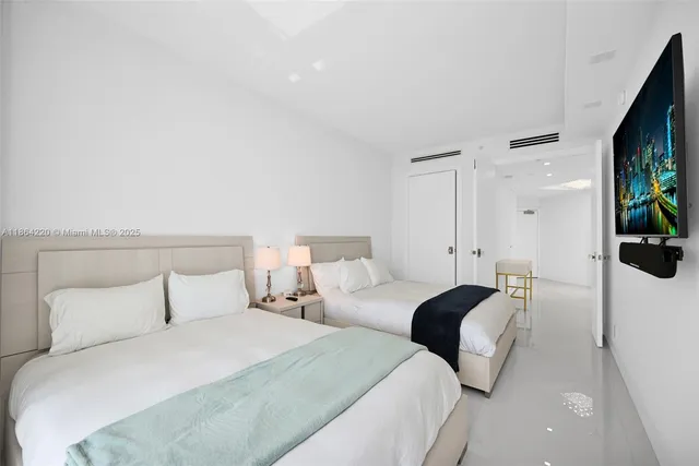 a bedroom with a bed and a flat screen tv