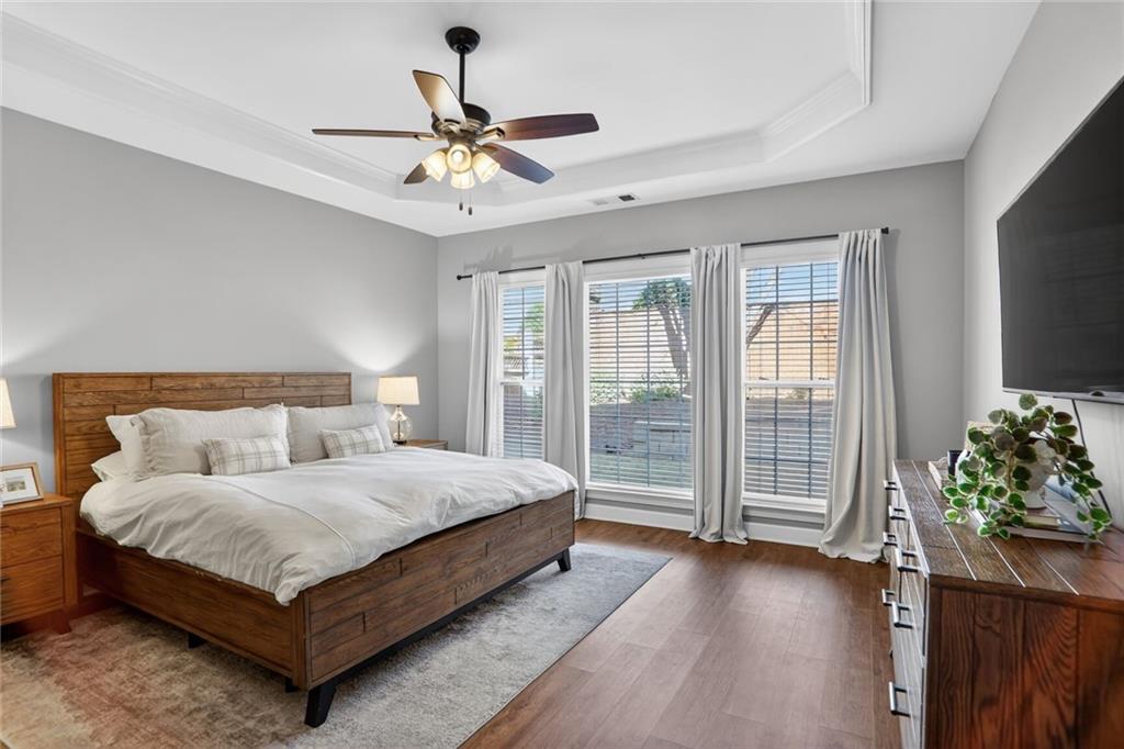 2355 Rosebrook Crossing Southeast Atlanta, GA 30339 - Photo 11 of 25 a bedroom with a large bed and a chandelier fan
