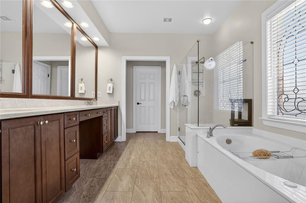 2355 Rosebrook Crossing Southeast Atlanta, GA 30339 - Photo 14 of 25 a spacious bathroom with a tub sink shower and mirror