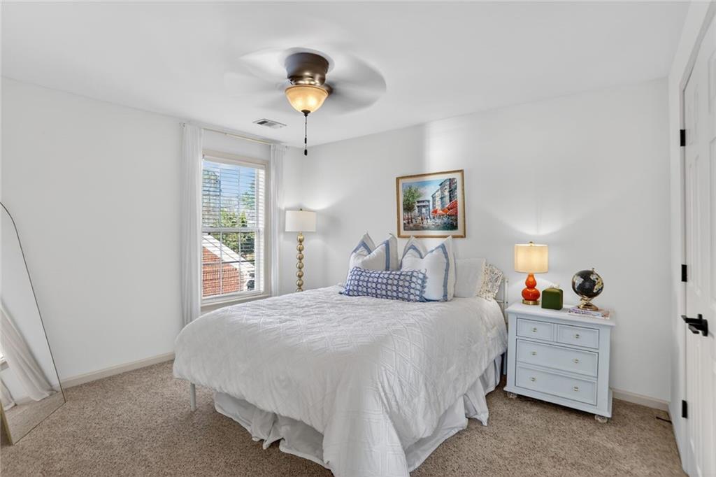 2355 Rosebrook Crossing Southeast Atlanta, GA 30339 - Photo 17 of 25 a bedroom with a bed and a chandelier