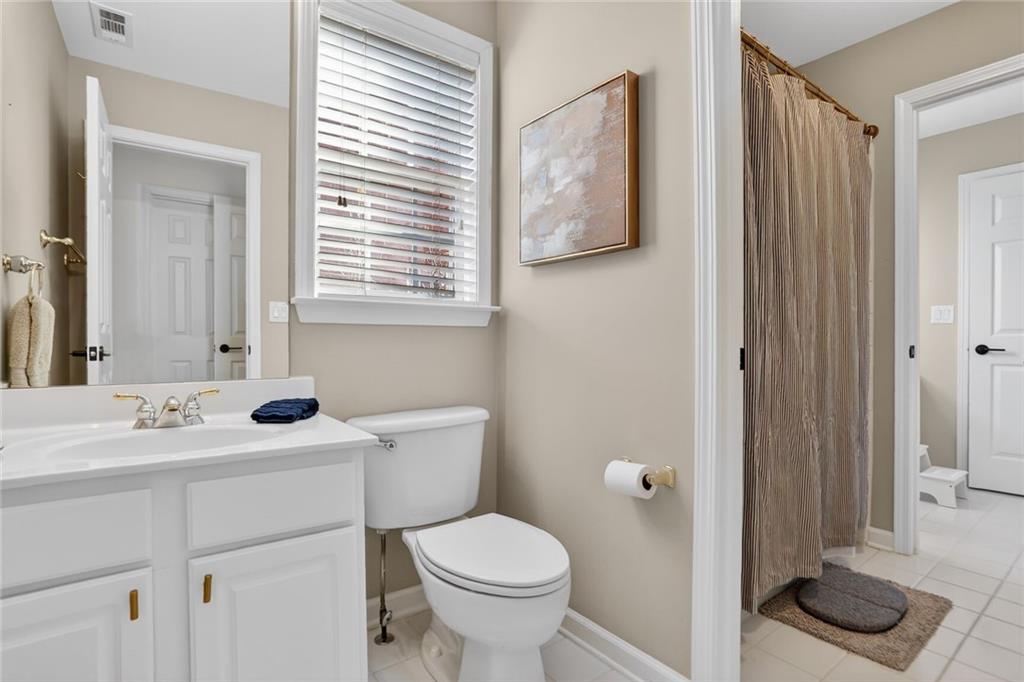 2355 Rosebrook Crossing Southeast Atlanta, GA 30339 - Photo 21 of 25 a bathroom with a toilet sink and mirror