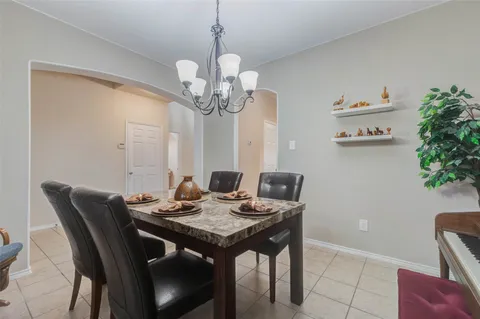 a view of a dining room with furniture wooden floor and a chandelier