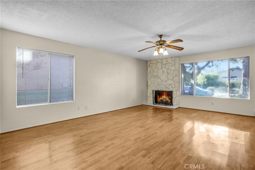 122 Tamarisk Street Redlands, CA 92373 - Photo 6 of 20 an empty room with chandelier fan and windows
