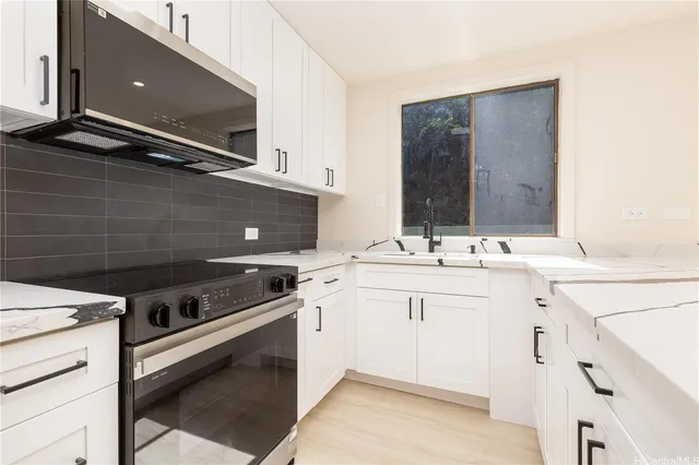 a kitchen with a sink stove and cabinets
