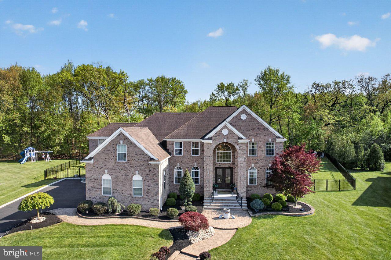 45 Emerald Road Robbinsville, NJ 08691 - Photo 7 of 57 Elegant brick home with lush greenery.