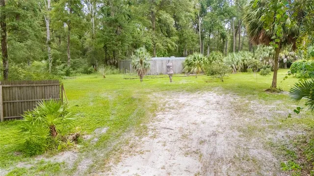 a view of a yard with trees