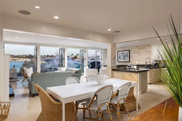 a dining room with furniture and a large window