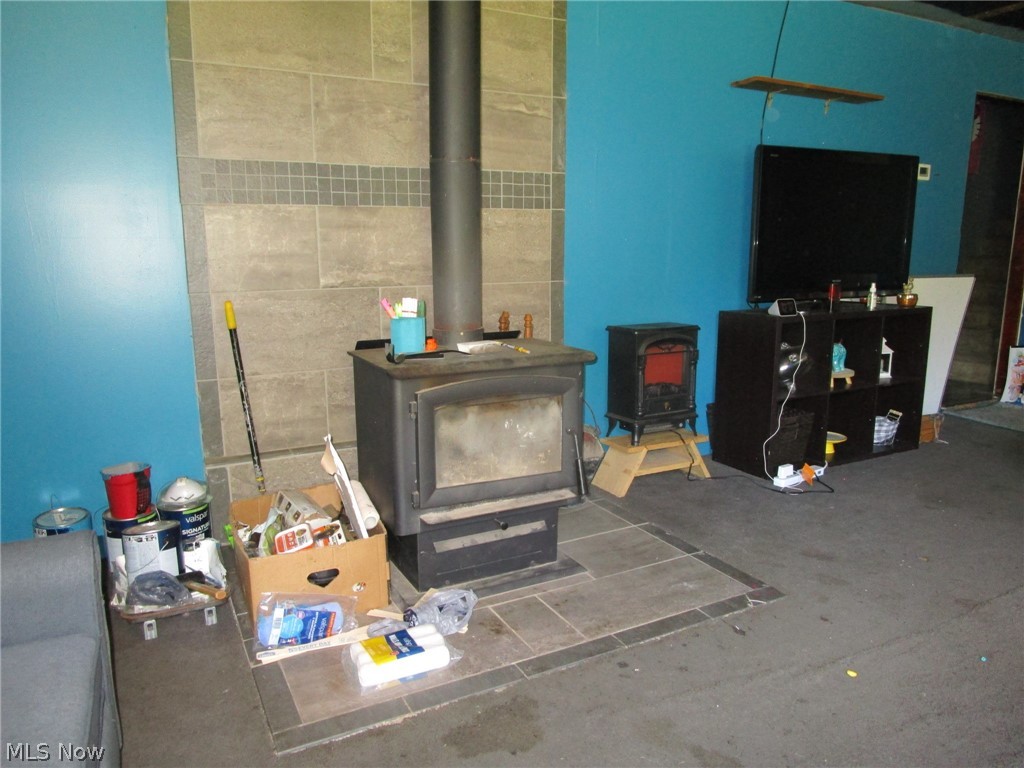 5560 Dodge Road Rome, OH 44085 - Photo 10 of 49 Living room featuring a wood stove