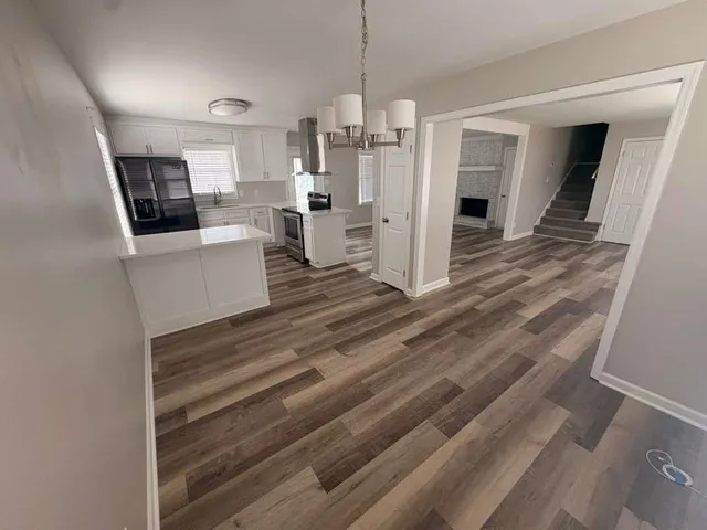 a open kitchen with white cabinets and stainless steel appliances