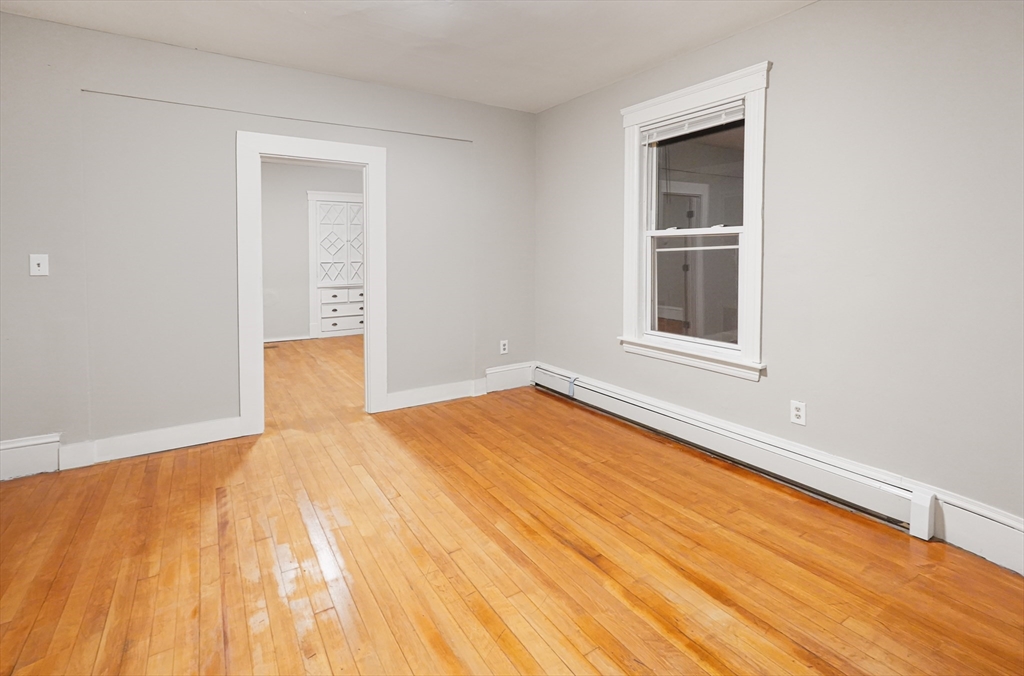 15 Mendon Street, Unit 3 Worcester, MA 01604 - Photo 7 of 28 a view of empty room with wooden floor and fan
