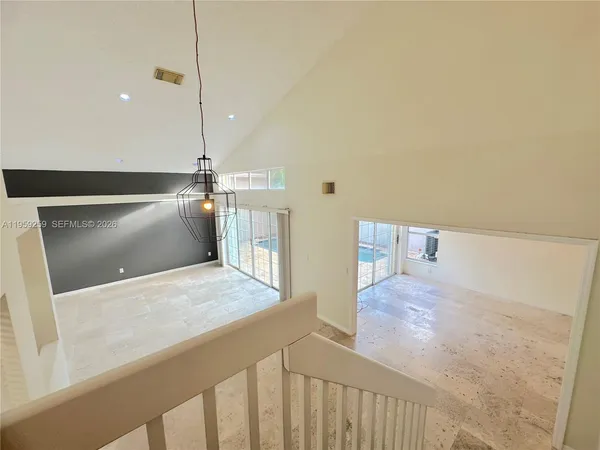 a living room with furniture and a floor to ceiling window