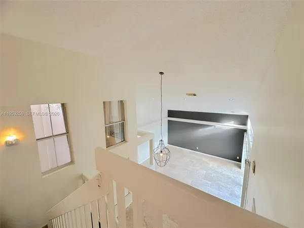 a view of a kitchen with a sink and a refrigerator