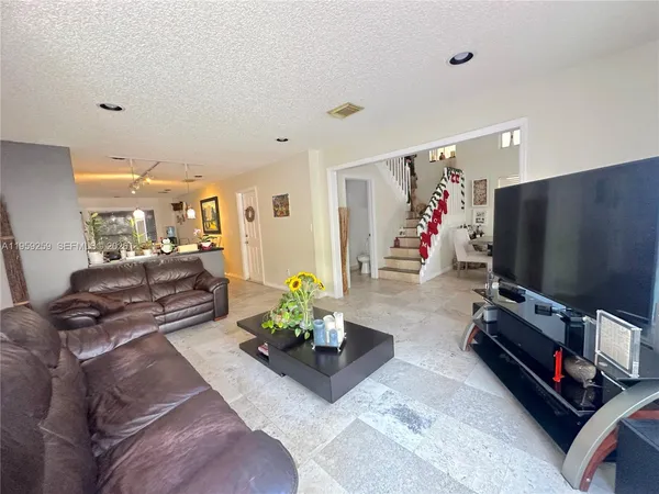 a view of a living room and kitchen