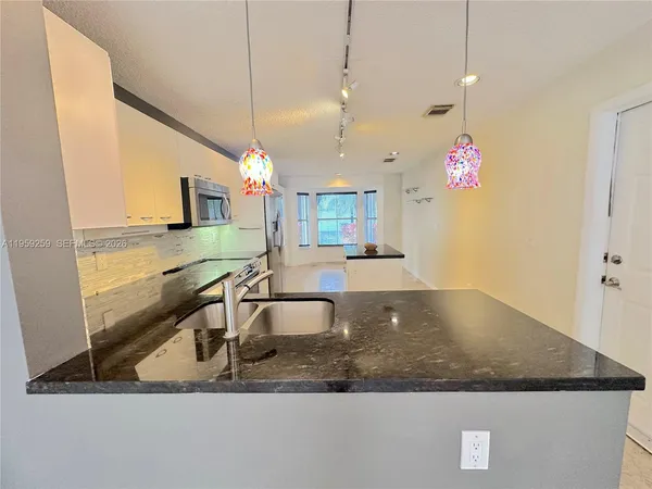 a living room with a table and chairs