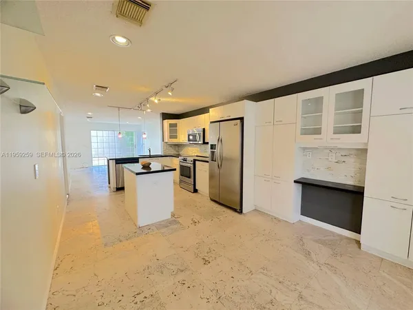 a view of a livingroom with furniture and a window