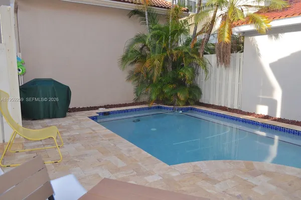 a view of a two chairs and table in the patio